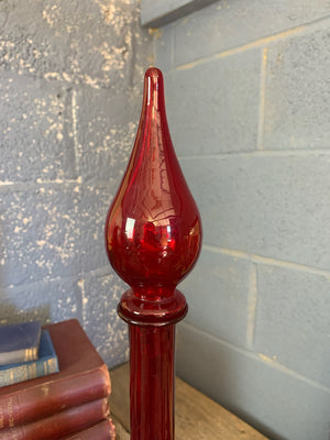 A large red glass carboy