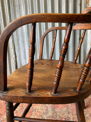 An oak spindle back captain's chair