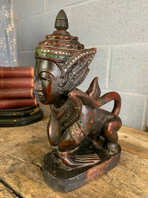 A carved wooden Manussiha sphinx statue