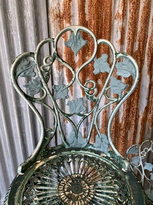 A green garden table and two chair bistro set