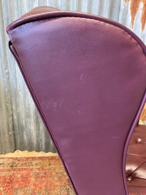 A burgundy leather full button tilt and swivel desk chair