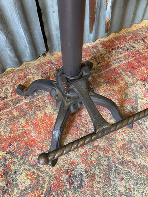 A cast iron adjustable tractor seat stool