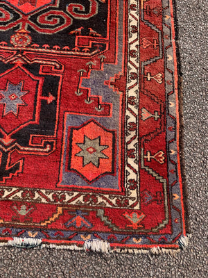 A Turkish red ground rug ~ 211cm x 138cm