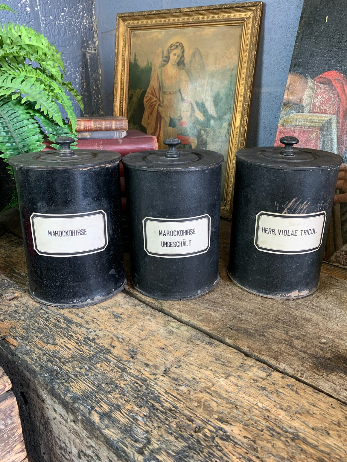 A set of three lidded wooden apothecary jars