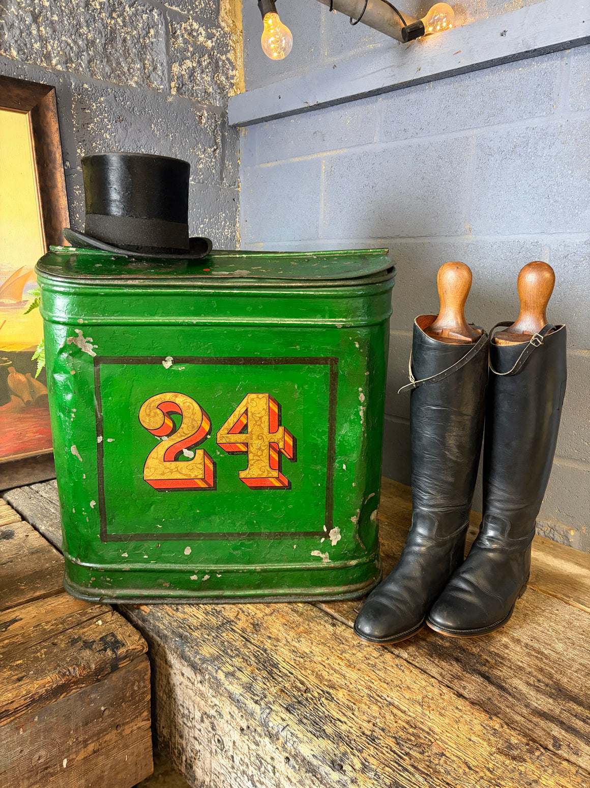 A large green lidded toleware tea canister