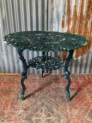 A green garden table and chairs set