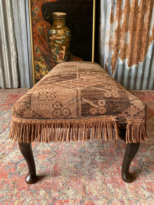 A large Persian carpet footstool