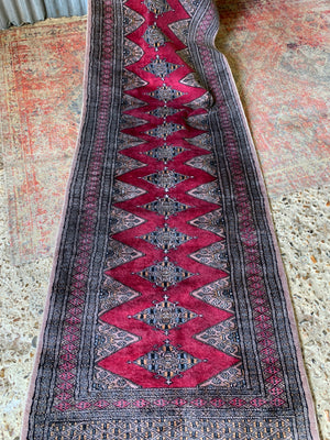 A long pink ground Persian runner rug ~ 318cm x 83cm