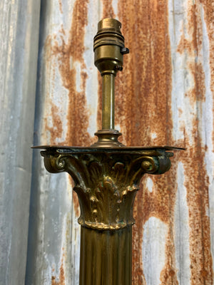 A brass Corinthian column standard lamp on lion paw feet