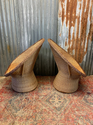 A pair of wicker egg chairs