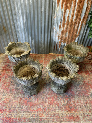 A pair of large acanthus cast stone urns