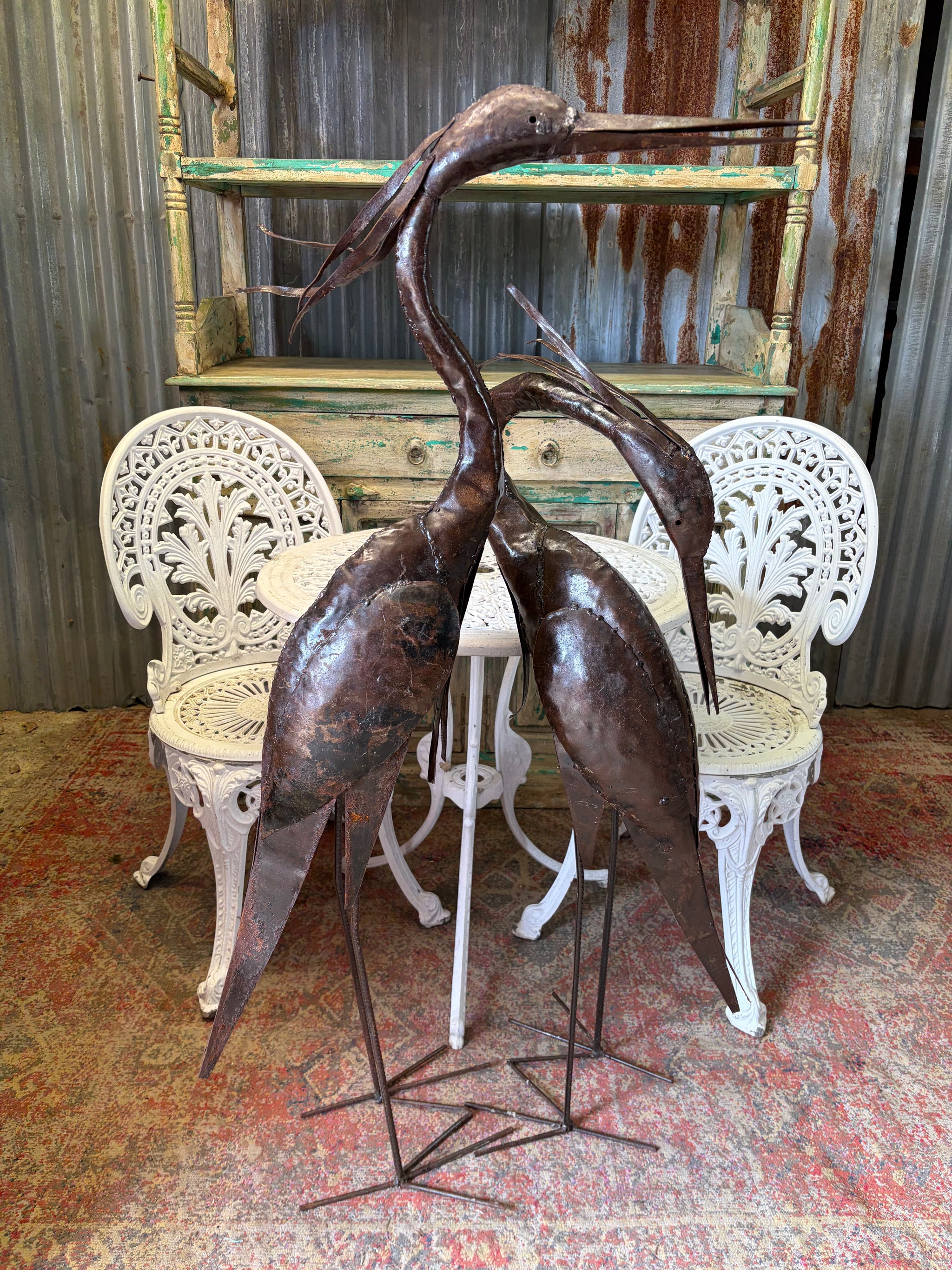 A pair of very large metal herons