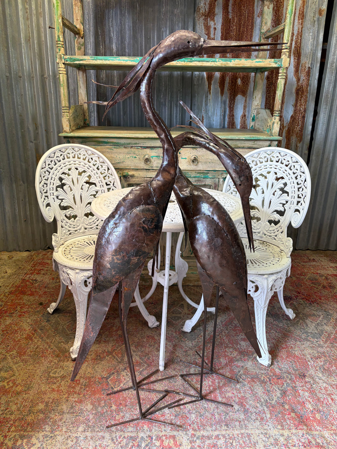 A pair of very large metal herons