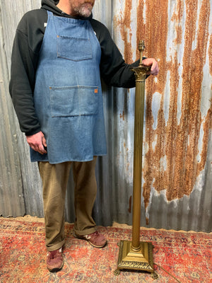 A brass Corinthian column standard lamp on lion paw feet