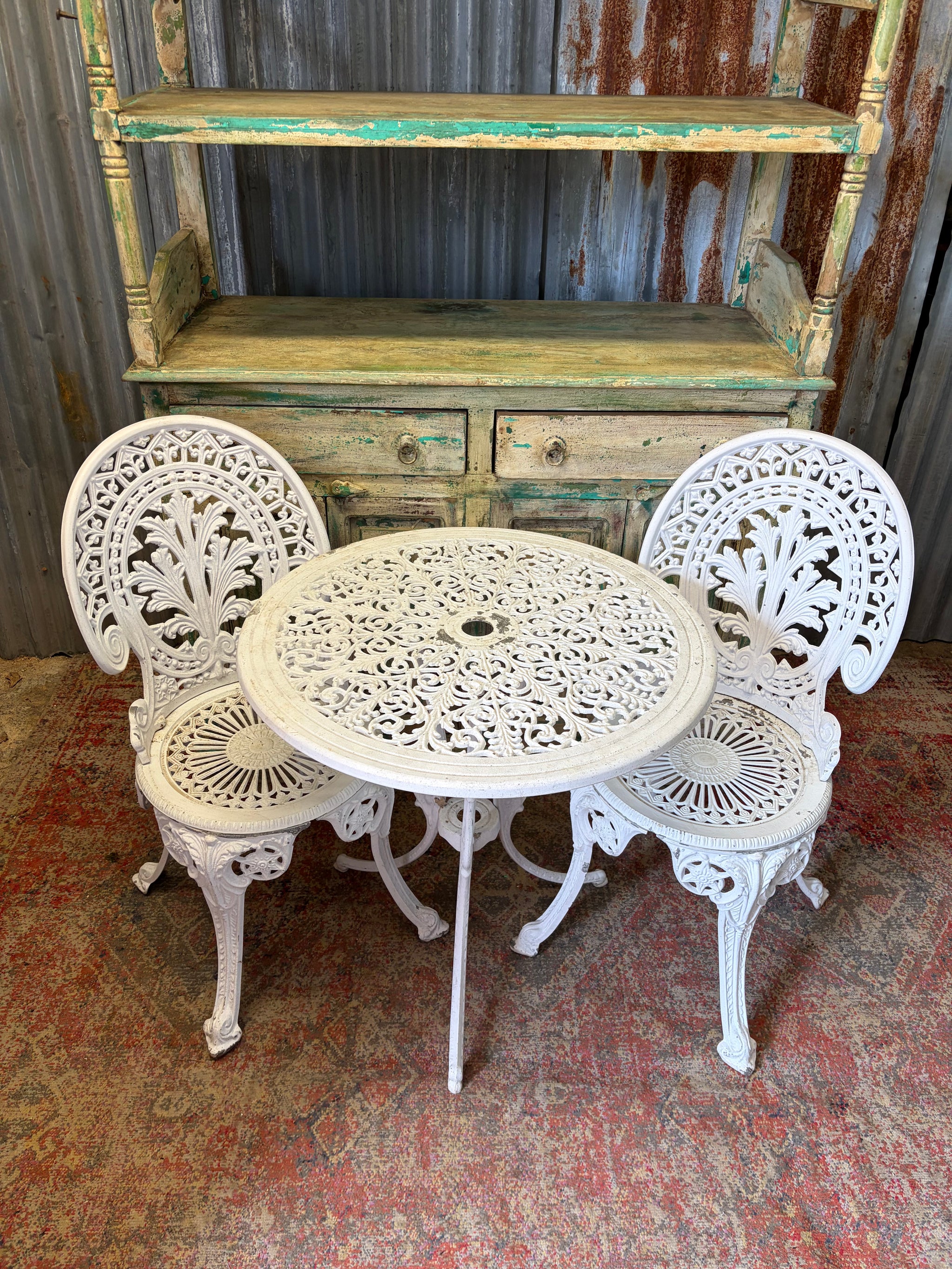 A white garden table and two chairs set