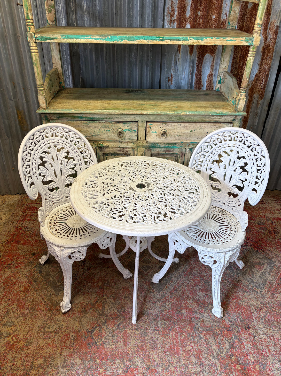 A white garden table and two chairs set