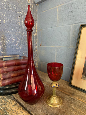 A large red glass carboy