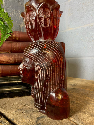 A carved bust of Tutankhamen in red Faturan