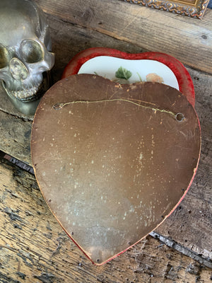 A pair of Victorian porcelain heart plaques on red velvet mounts