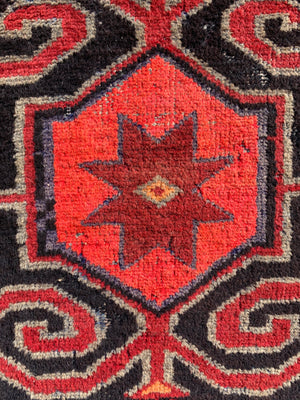 A Turkish red ground rug ~ 211cm x 138cm