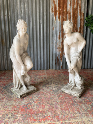 A pair of cast stone Pandora statues