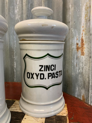 A set of three white ceramic apothecary jars