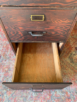 A large wooden filing cabinet with four drawers