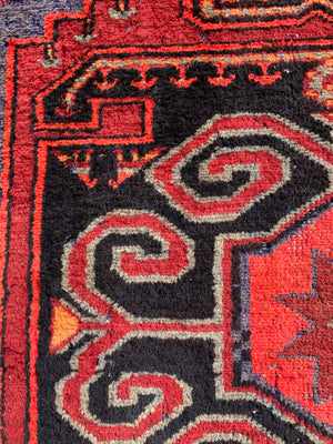 A Turkish red ground rug ~ 211cm x 138cm