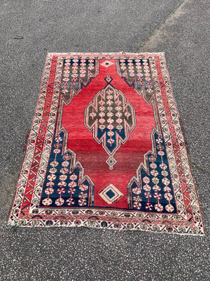 A rectangular red ground Persian rug ~ 190cm x 128cm