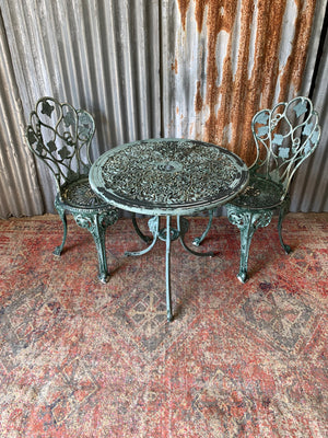 A green garden table and two chair bistro set