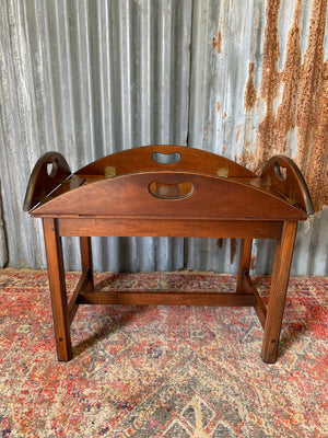 A mahogany butler's tray table