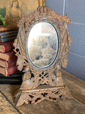 A cast iron table top mirror