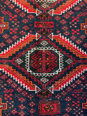 A Persian red & blue ground rectangular rug ~ 179cm x 96cm