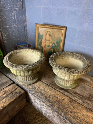 A pair of large cast stone gadrooned urns