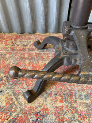 A cast iron adjustable tractor seat stool