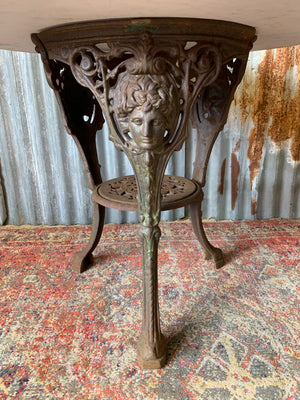 A cast iron Britannia garden table with marble top