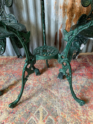 A green garden table and chairs set