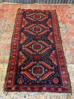 A Persian red & blue ground rectangular rug ~ 179cm x 96cm