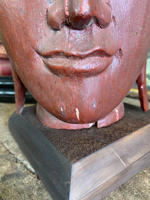 A carved wooden Buddha head