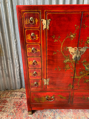 A red and gold lacquered chinoiserie cabinet