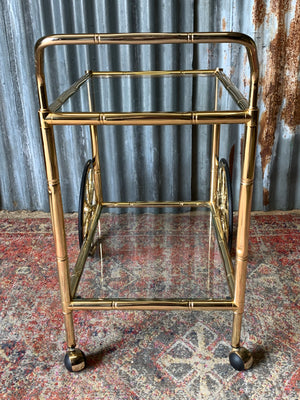 A faux bamboo Hollywood Regency two tier trolley