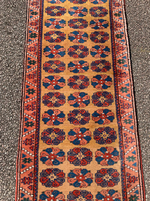 A long yellow ground red blue Persian runner rug ~ 257cm x 67cm