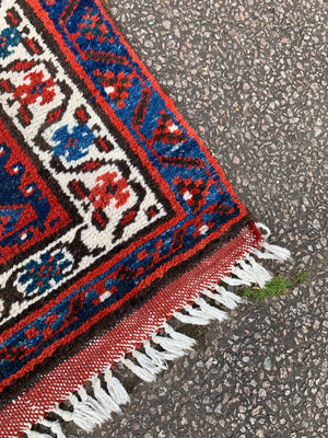 A long red ground blue Persian runner rug ~ 304cm x 104cm