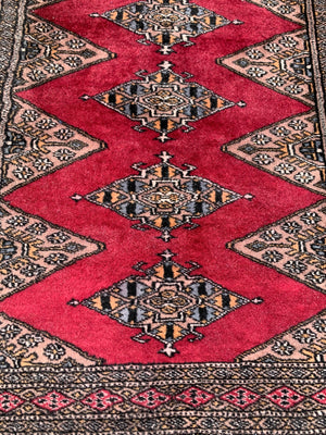 A long pink ground Persian runner rug ~ 318cm x 83cm