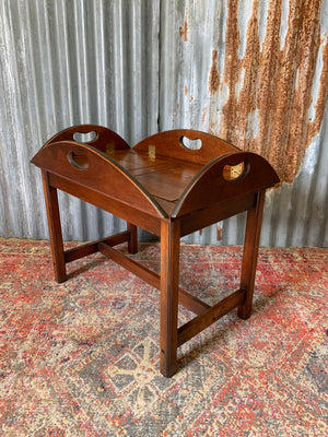 A mahogany butler's tray table