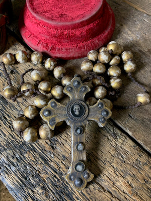 A set of oversized wooden rosary beads with memento mori motif