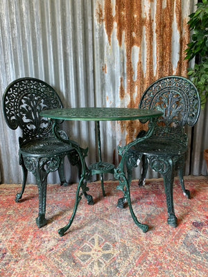 A green garden table and chairs set