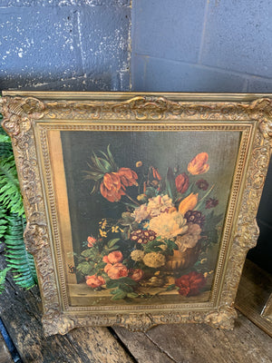 A framed floral oleograph