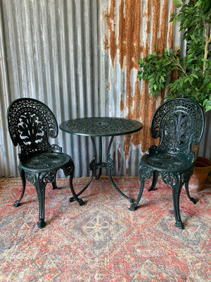 A green garden table and chairs set