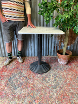 A cast iron garden table with heavy marble top ~ A